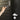 Hand holding a smartphone with a smart lock app, approaching a door with a digital lock.