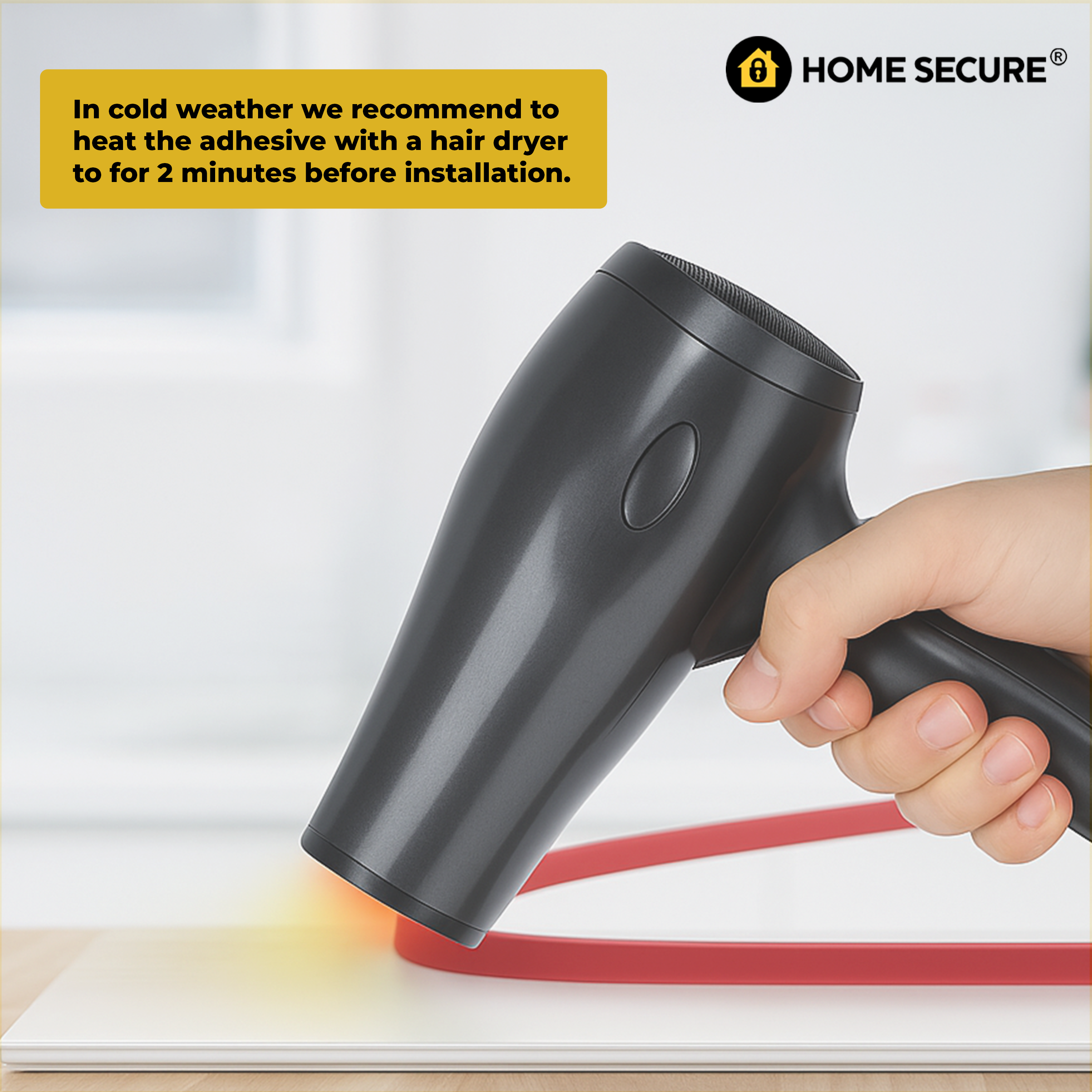 Hair dryer being used to heat adhesive on door draught excluder with text and Home Secure logo.