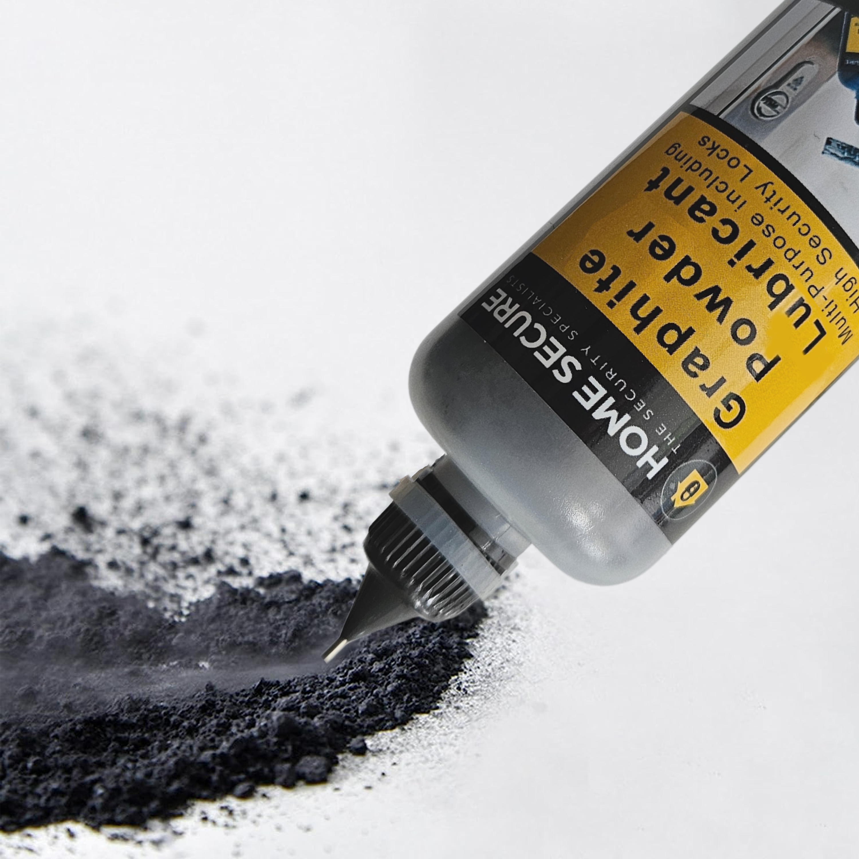Close-up of a Home Secure Graphite Powder Lubricant bottle dispensing fine black powder onto a white surface