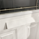 Close-up of a white front door with a rectangular mail slot cover installed beneath a decorative glass panel. The mail slot flap is angled outward, matching the door's white color and clean design