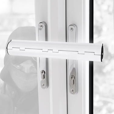 A white Patio door / French door security lock installed on a French double door, with a simulated intruder visible in the background.