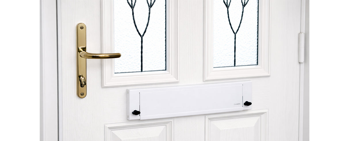 FlapGUARD lockable letterbox cover shown in use on a front door.