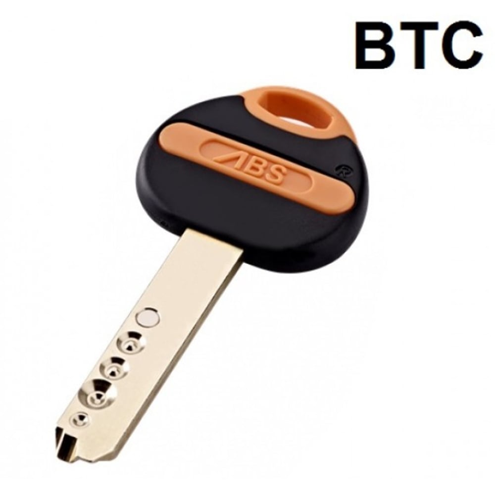A key with a black and orange head, featuring the ABS logo, and a gold-colored shaft with cut grooves for the cylinder.