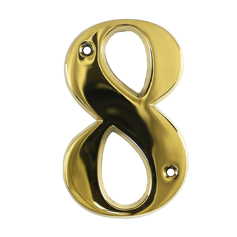 A gold-colored metal house number in the shape of the numeral 8.