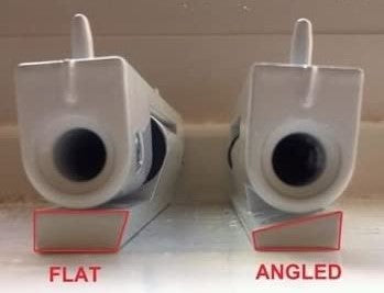 Close-up photo of two white door latch mechanisms placed side by side on a flat surface.