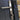 Close-up of a modern door handle with electronic keypad on a dark surface.