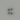 Four metallic jack nuts on a grey background