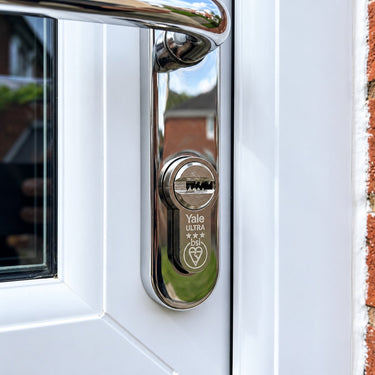 Yale Platinum Ultra 3 star euro cylinder fitted in a chrome handle on a white uPVC front door