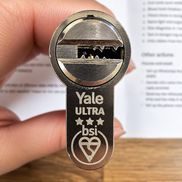 Close-up of the Yale Platinum Ultra cylinder face showing the dimple keyway, three stars and the BSI Kitemark