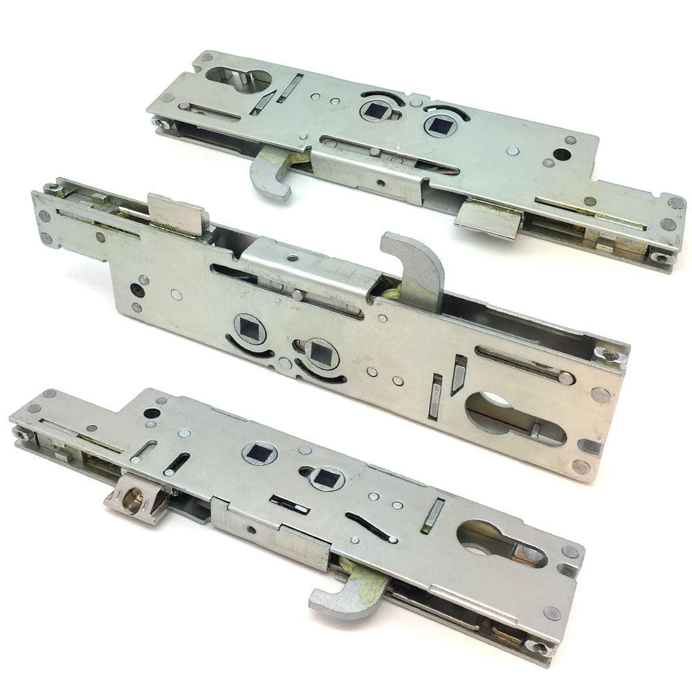 A set of metallic door lock center cases and gearboxes, typically used in multipoint door lock systems.