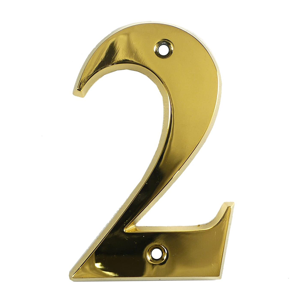 A gold metal house number in the shape of the numeral 2.