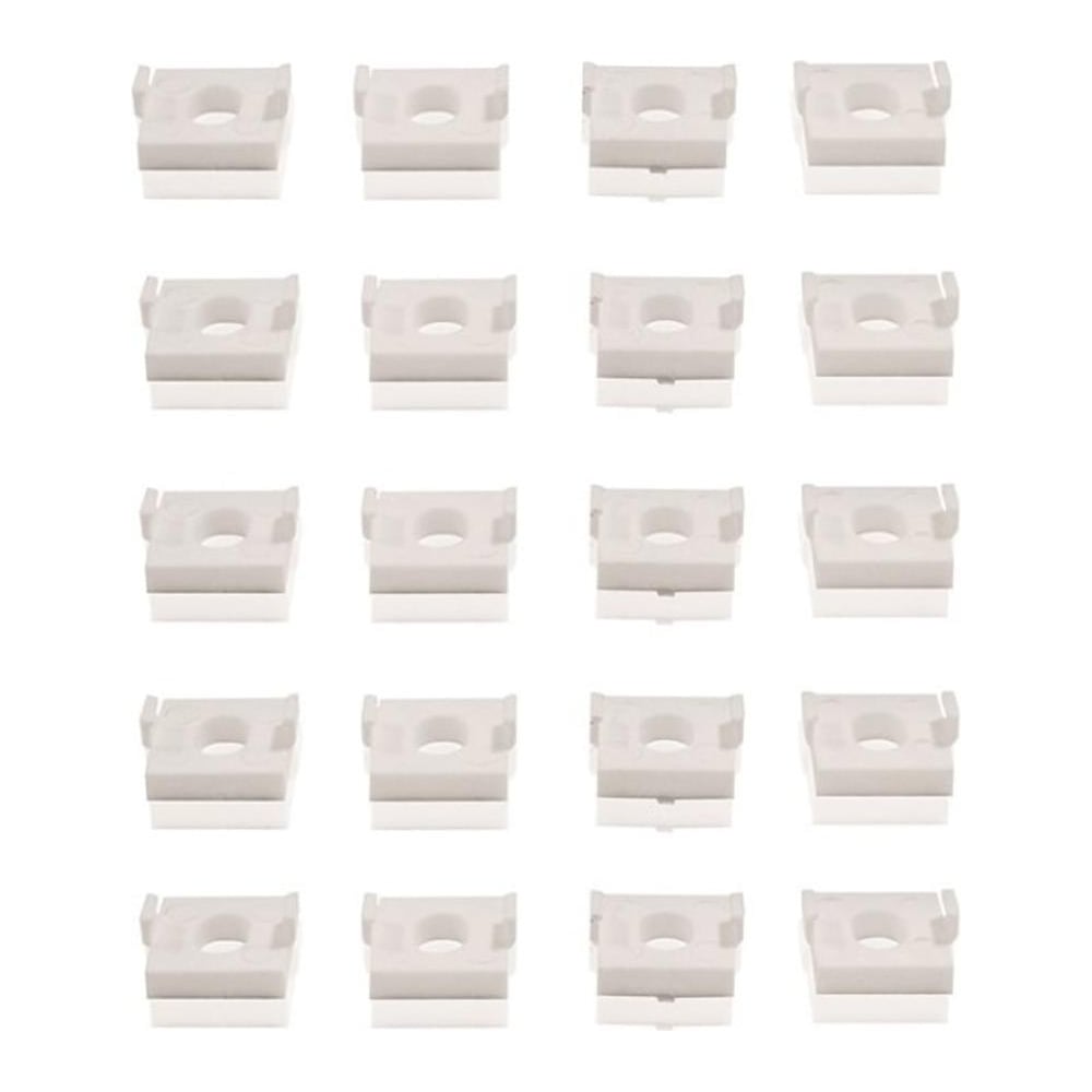 A collection of white plastic window hinge friction stay packers arranged in a pattern.