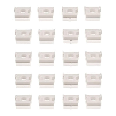 A collection of white plastic window hinge friction stay packers arranged in a pattern.