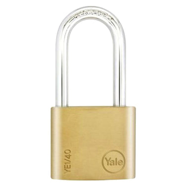 A gold-colored Yale brass padlock with a chrome plated steel shackle and a key inserted in the lock.