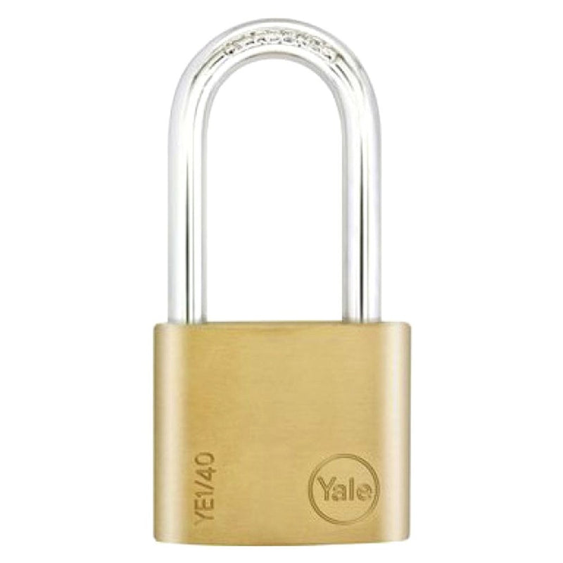 A gold-colored Yale brass padlock with a chrome plated steel shackle and a key inserted in the lock.